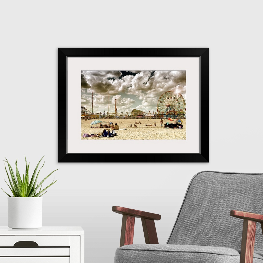 A modern room featuring Photo of dramatic clouds over the sandy beach of Coney Island with carnival rides in the background.