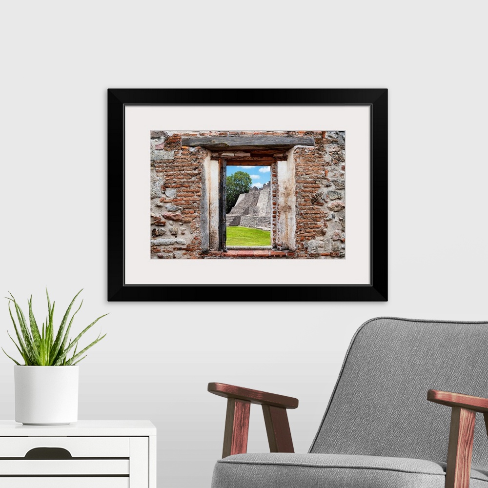 A modern room featuring View of a Mayan Pyramid framed through a stony, brick window. From the Viva Mexico Window View.