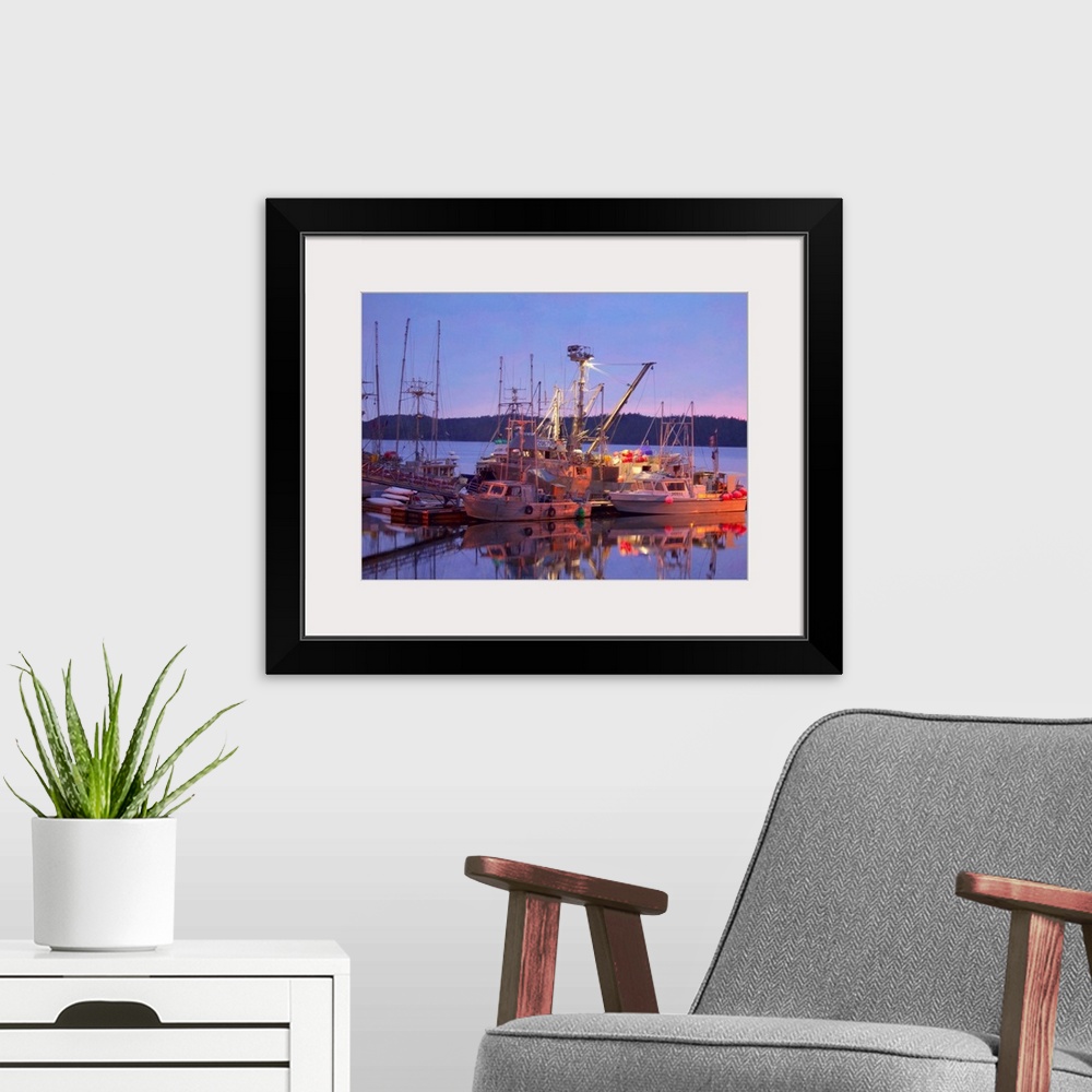 A modern room featuring Pictorialist photo of fishing boats reflected in the water while docked.