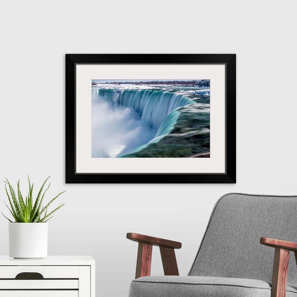 A modern room featuring The impressive Niagara Falls in February.