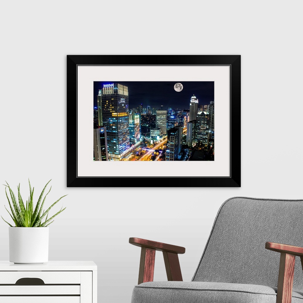 A modern room featuring Moon over the city of Jakarta, Indonesia, at night.