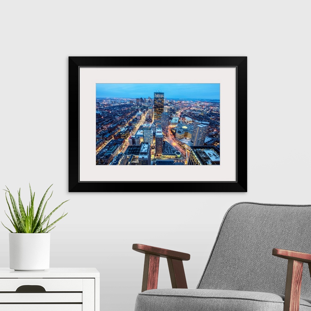A modern room featuring Photo of Boston cityscape at night featuring the John Hancock Tower.