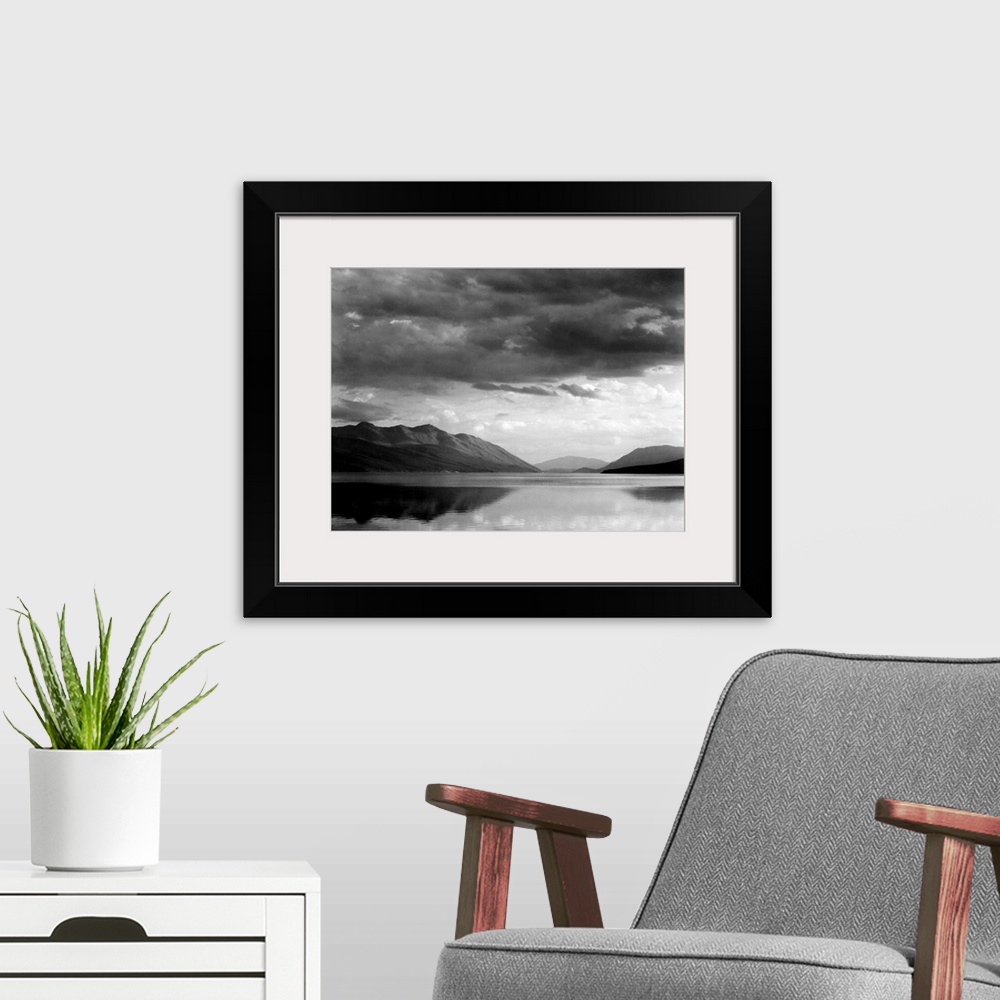 A modern room featuring Evening, McDonald Lake, Glacier National Park, looking across lake to mountains and clouds.