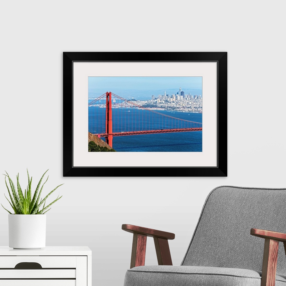 A modern room featuring Photograph of the Golden Gate Bridge with San Francisco's skyscrapers in the background.