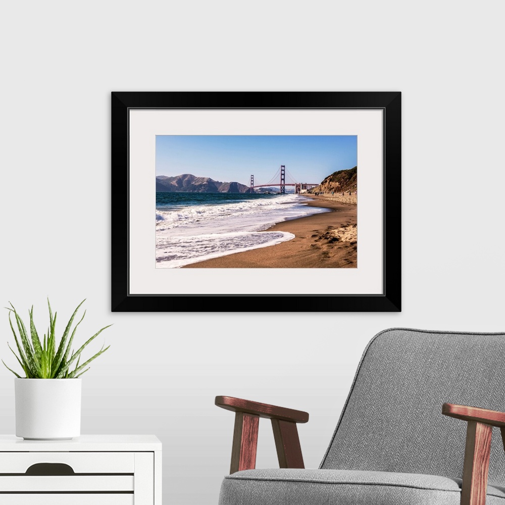 A modern room featuring Landscape photograph of a view of the Golden Gate Bridge from the pacific coast.