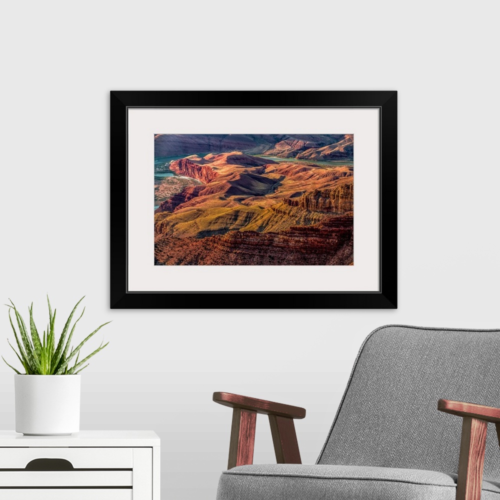 A modern room featuring Landscape photograph of the Colorado River winding through the Grand Canyon.