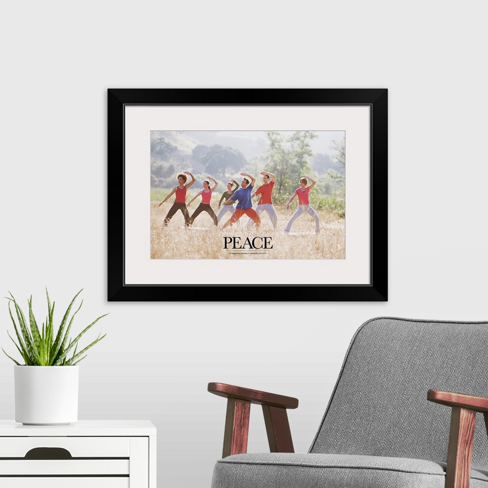 A modern room featuring Uplifting poster with a group of people doing yoga and meditation exercises in a grassy field wit...