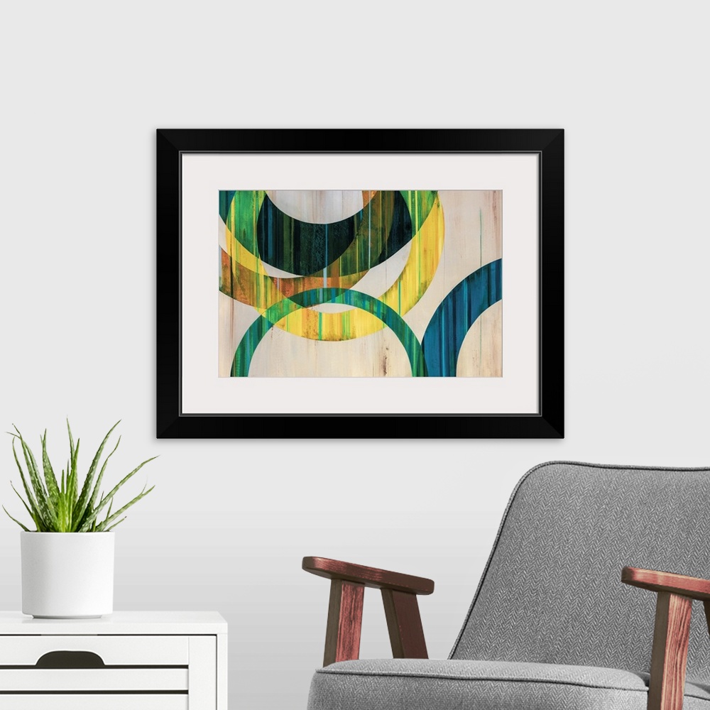 A modern room featuring Modern abstract art of circular rings painting in shades of blue, green, yellow, and orange over ...