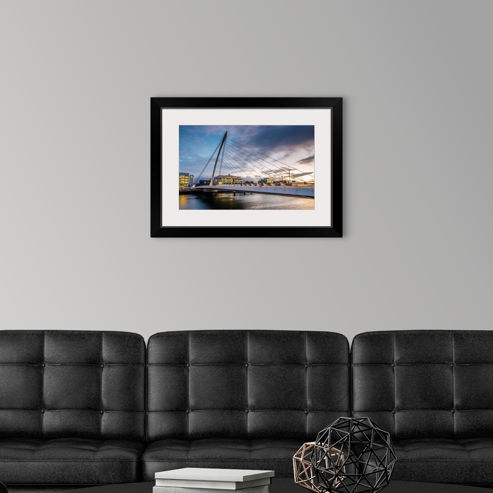 A modern room featuring Photograph of the Samuel Beckett Bridge, a cable-stayed bridge in Dublin, Ireland going across th...