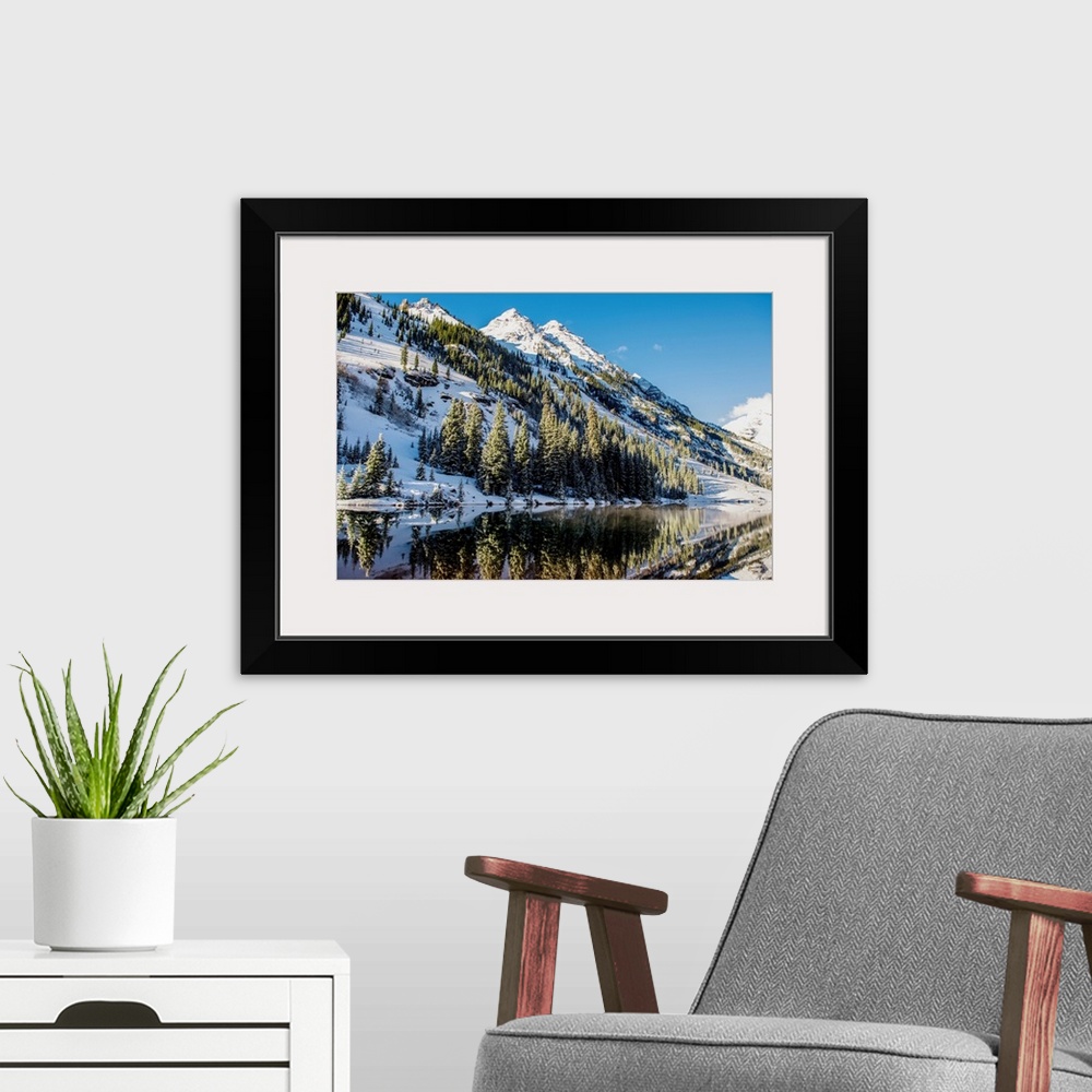 A modern room featuring Summer snow on pine trees and the mountain side at the edge of Maroon Lake in the Maroon Bells, A...