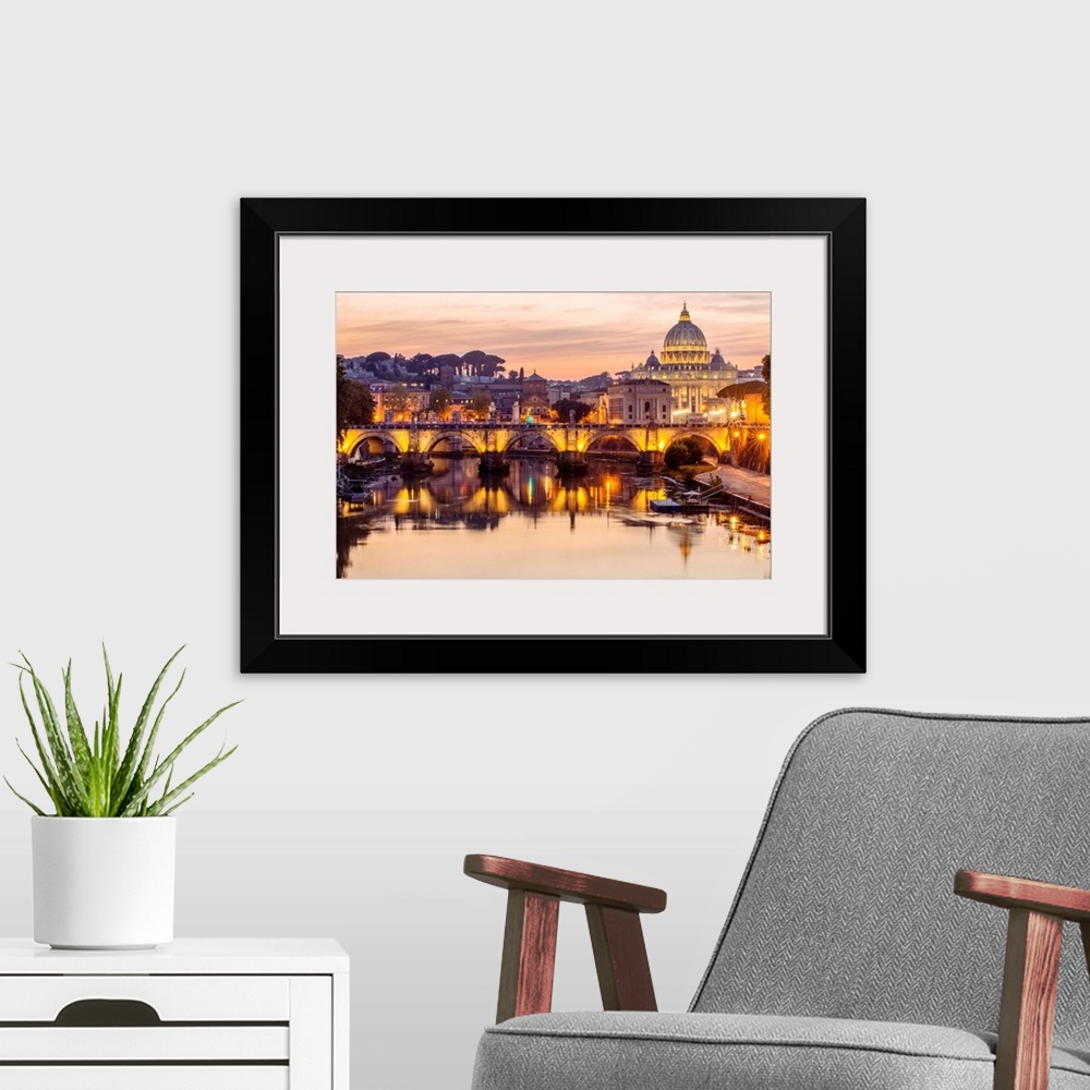 A modern room featuring A view of St. Peter's Basilica in the Vatican and the Ponte Sant'Angelo  spanning across the rive...