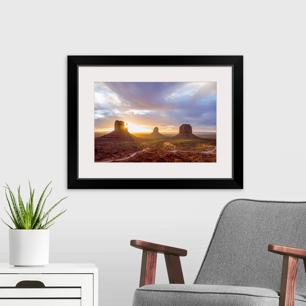 A modern room featuring Sunrise at the Mittens and Merrick Buttes in Monument Valley, Arizona.