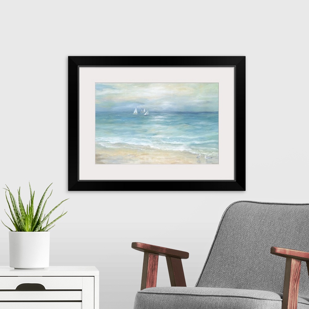 A modern room featuring A contemporary painting of a seascape with sailboats off in the distance and shorebird walking al...