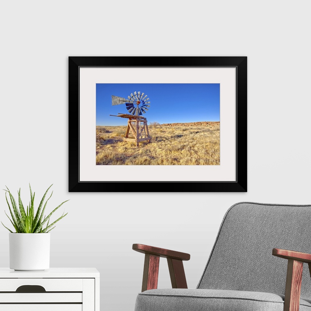 A modern room featuring An old windmill marking the boundary of the Devil's Playground in Petrified Forest National Park,...