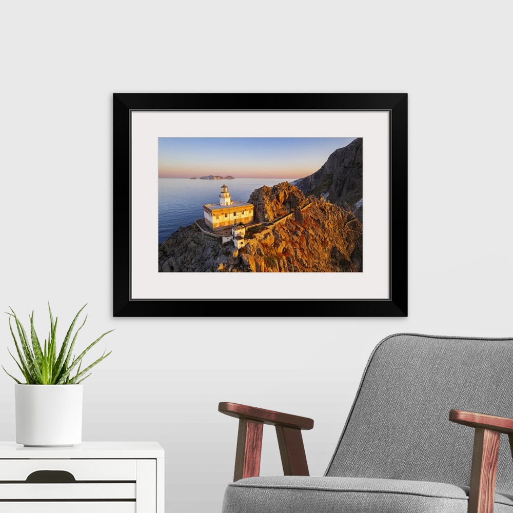 A modern room featuring Aerial view of Punta della Guardia lighthouse on top of a cliff on the island of Ponza, lit from ...