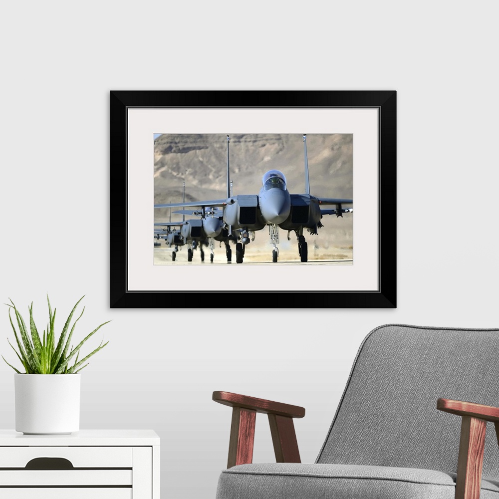 A modern room featuring November 26, 2013 - A group of F-15E Strike Eagles taxi following a combat mission during Blue Fl...
