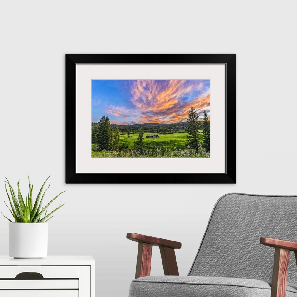 A modern room featuring July 9, 2014 - A high dynamic range photo of a sunset over a log cabin at Cypress Hills Interprov...