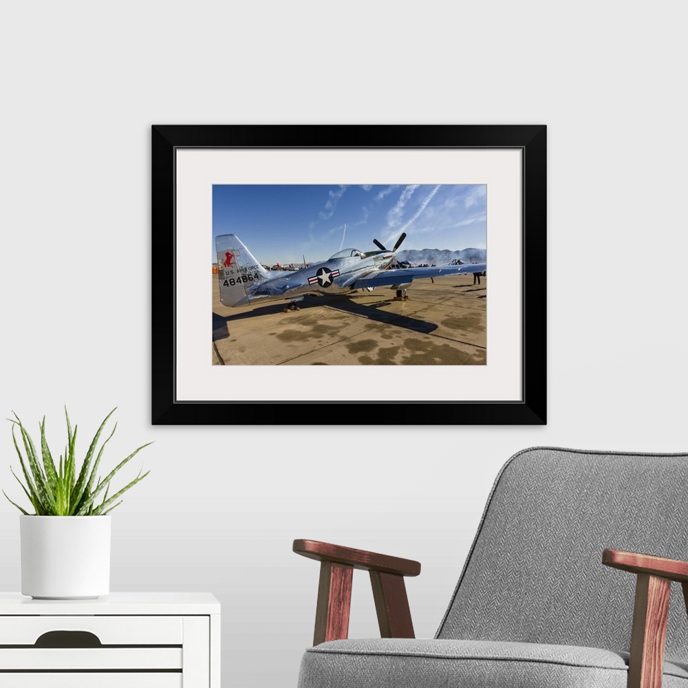 A modern room featuring A P-51 Mustang parked on the ramp at Nellis Air Force Base, Nevada.