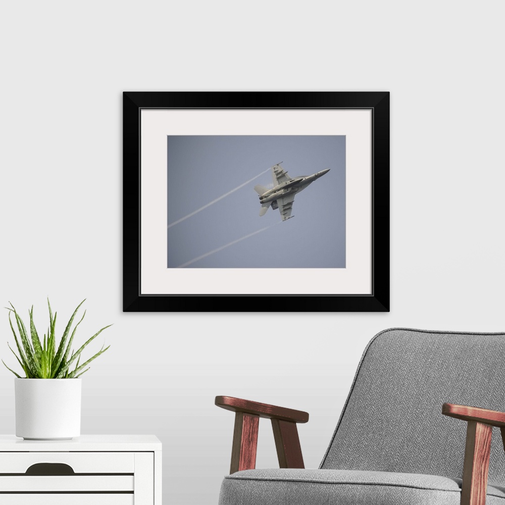A modern room featuring August 22, 2013 - An F/A-18E Super Hornet in flight over the Gulf of Oman.