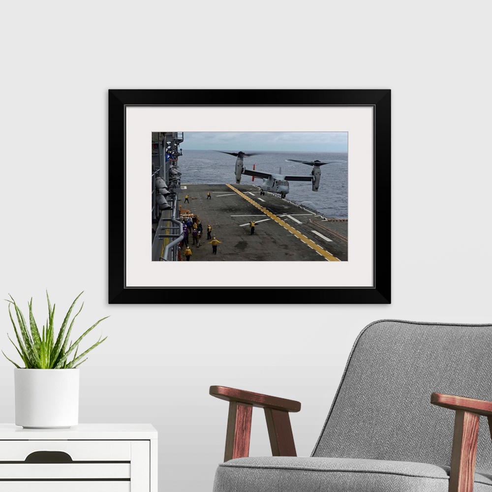 A modern room featuring South China Sea, February 19, 2014 - An MV-22 Osprey tiltrotor aircraft prepares to land on the f...