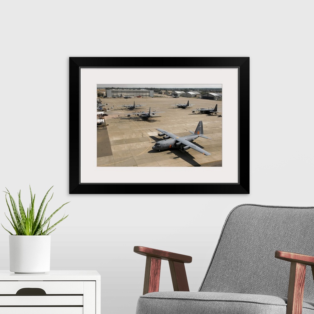 A modern room featuring C130 Hercules aircraft stationed at an airbase