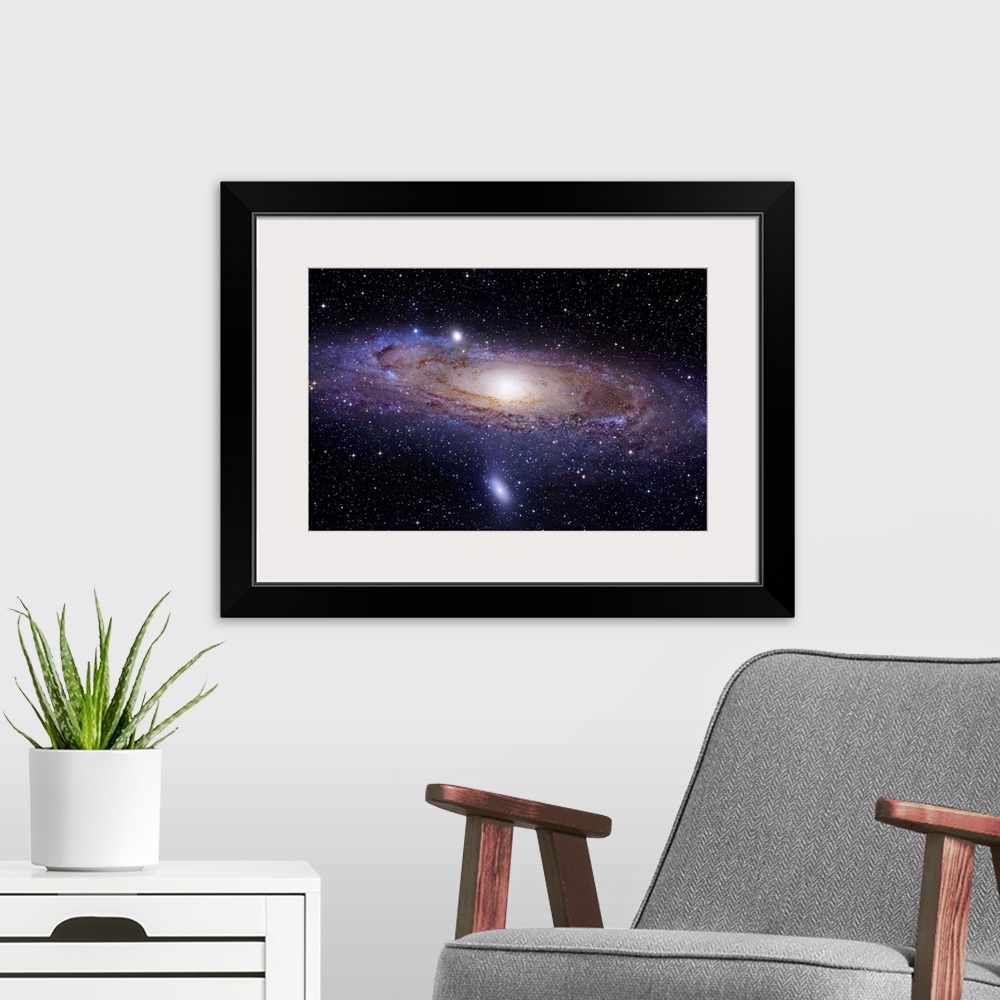 A modern room featuring Landscape photograph of a spiral galaxy 2.5 million light years away.