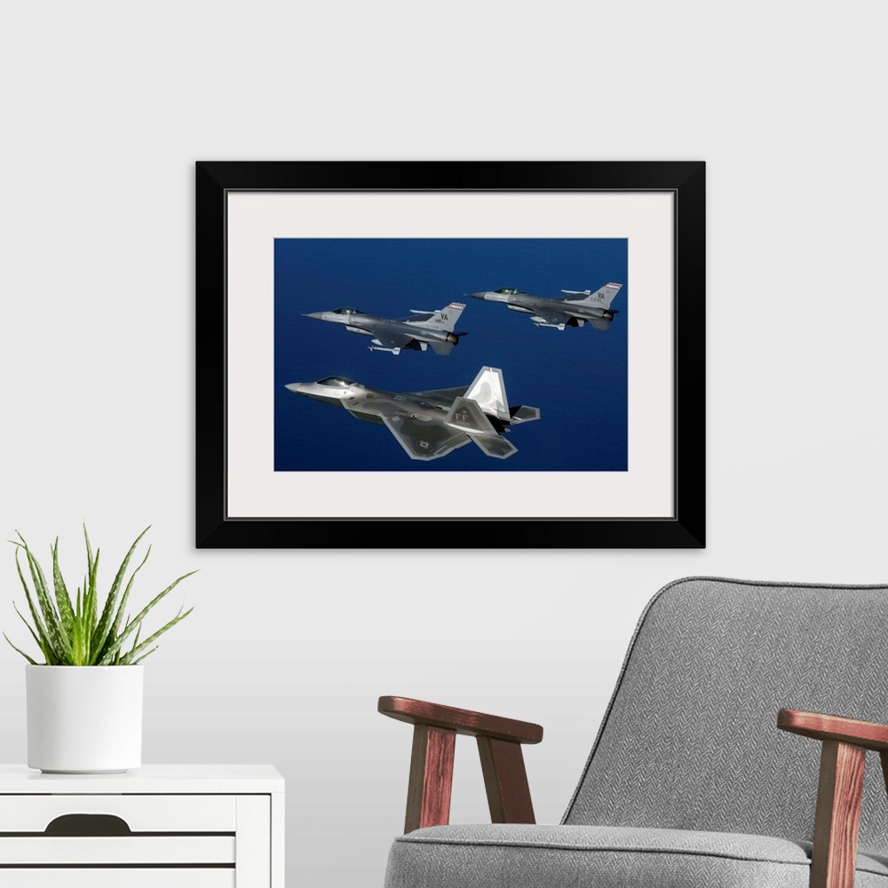 A modern room featuring Three F-22A Raptor aircrafts fly in formation.