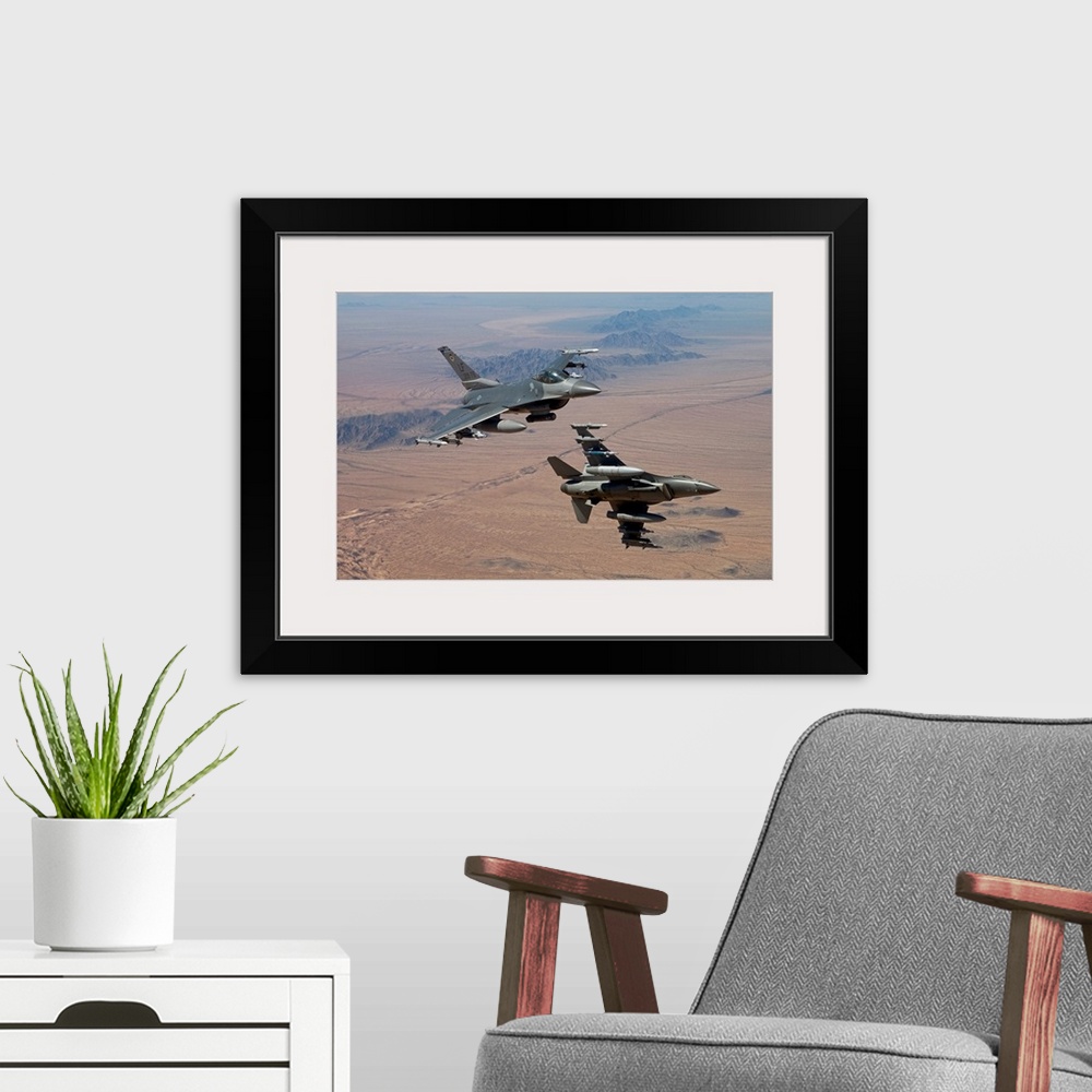 A modern room featuring Two F-16's from the 56th Fighter Wing at Luke Air Force Base, Arizona, manuever on a training mis...