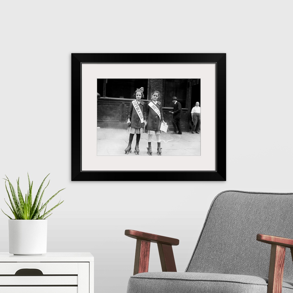 A modern room featuring Two young strike sympathizers on rollerskates, probably in New York City. Photograph, c1915.