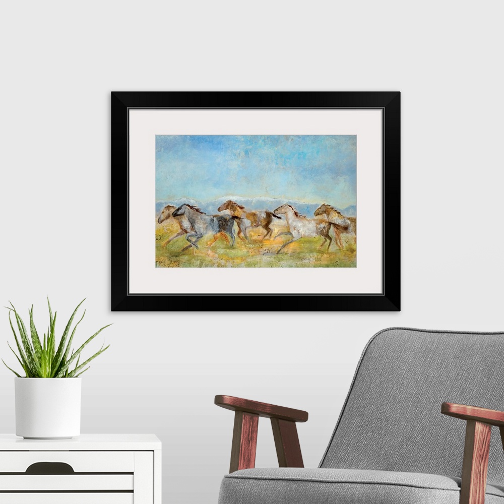 A modern room featuring A landscape painting of wild horses running across the plains; the horses have been painted with ...