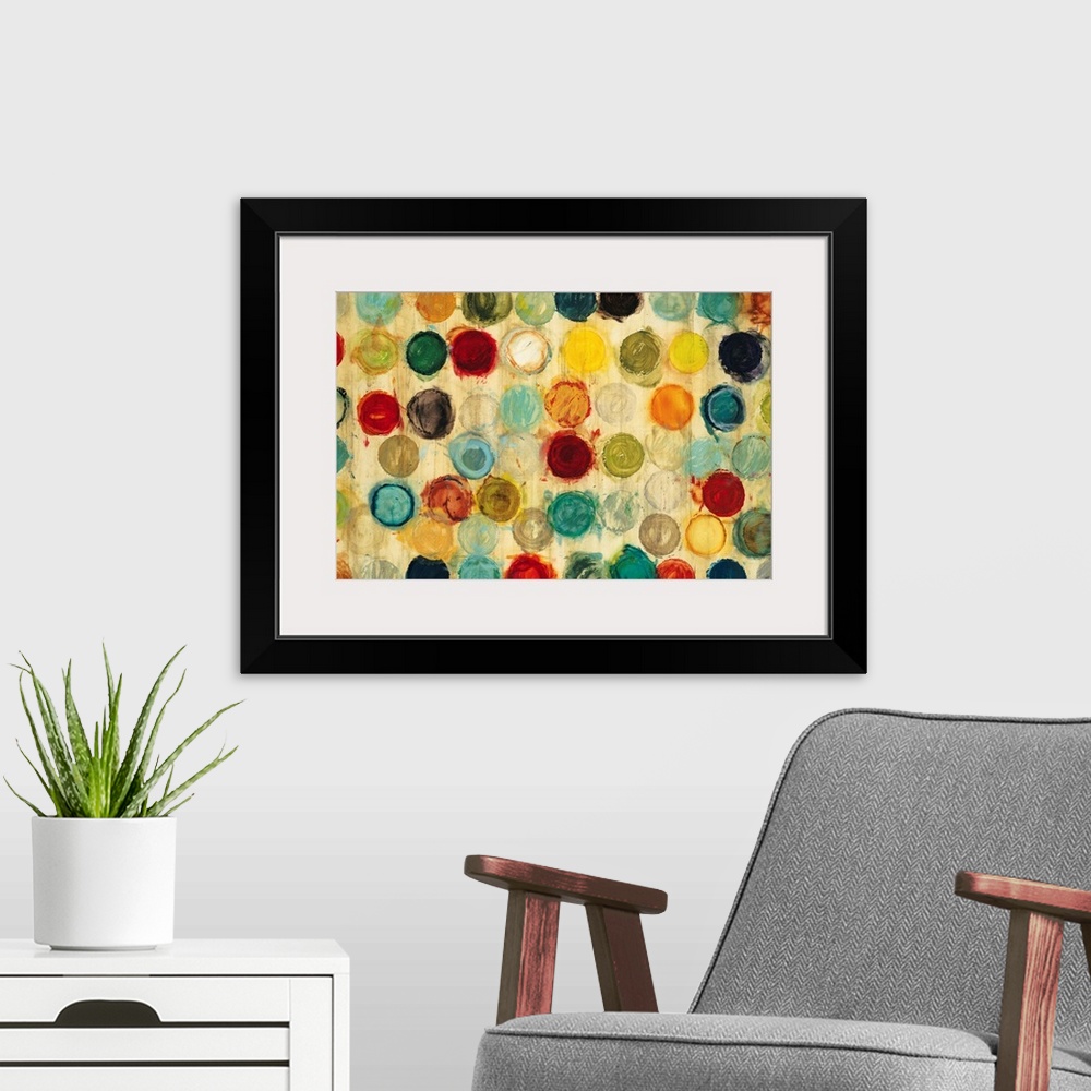 A modern room featuring Abstract artwork of a collection of multicolored circles, all of the same size, arranged in semi-...