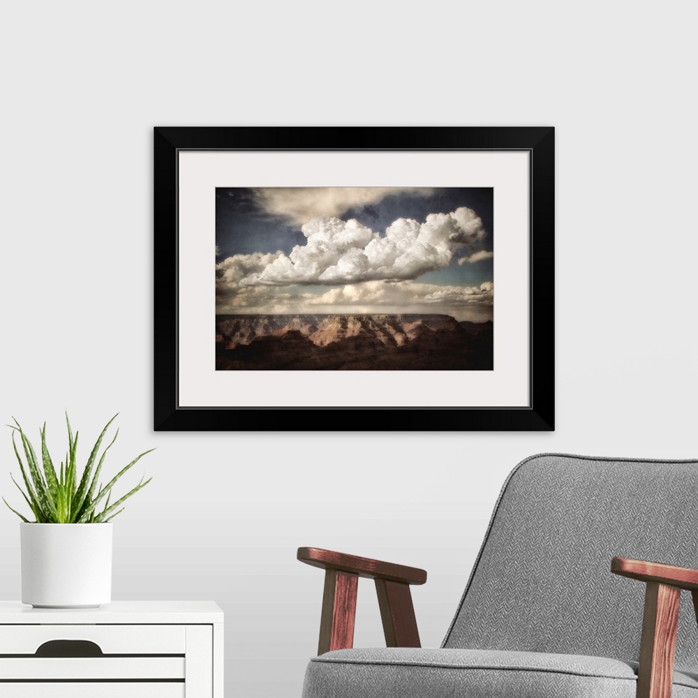 A modern room featuring Huge canyon in the background looking across the Grand Canyon in USA with clouds in a blue summer...