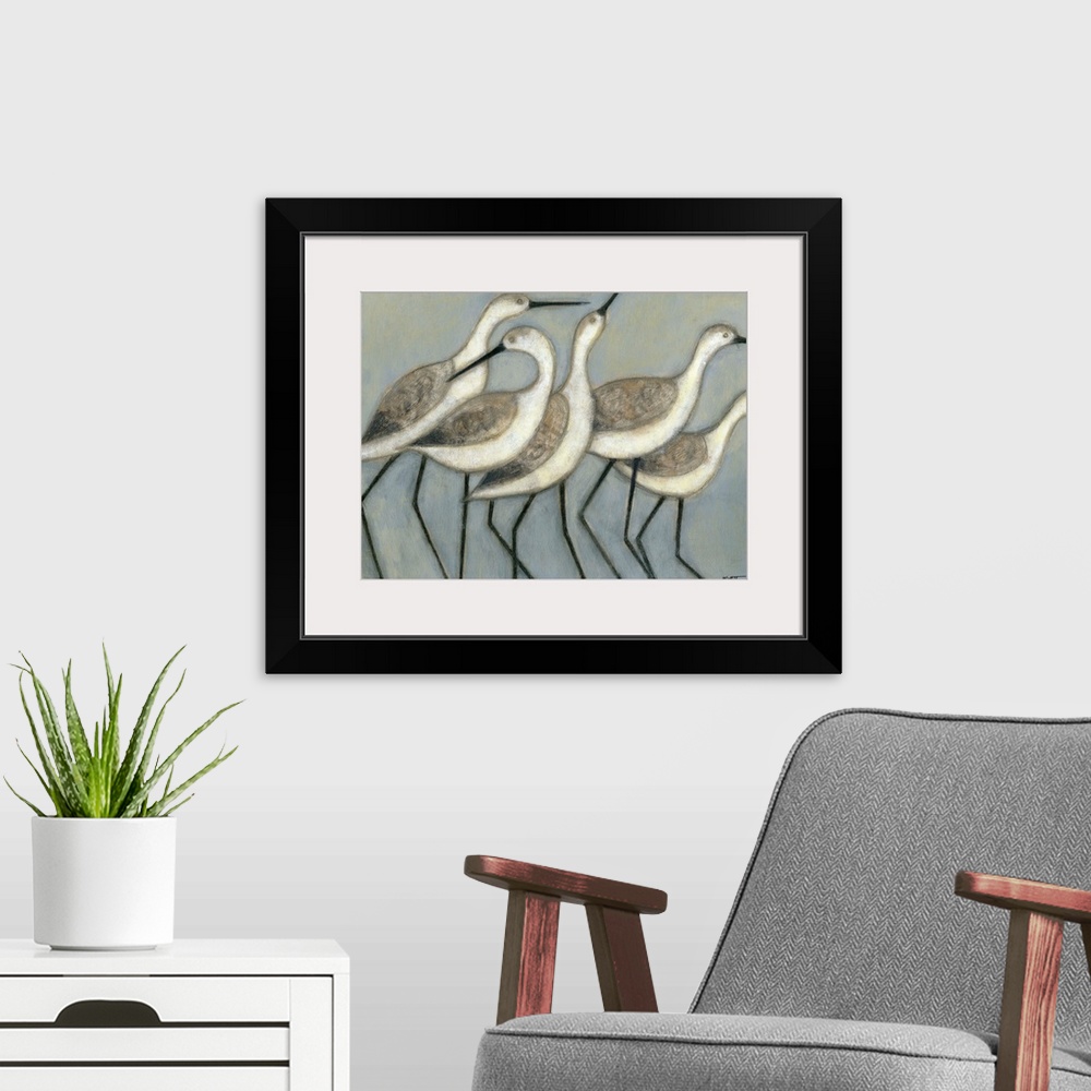 A modern room featuring A group of wader birds stand next to each other against a cool toned background.