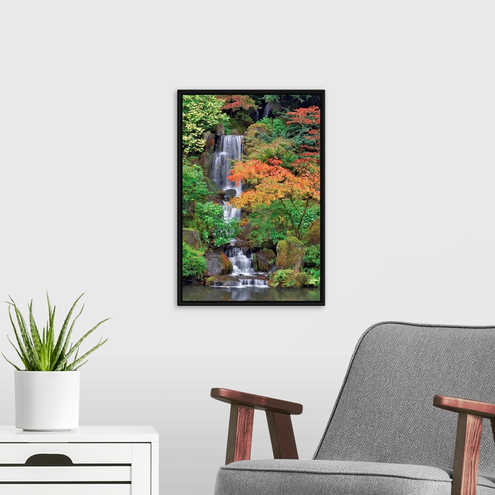 A modern room featuring Photograph of waterfall surrounded by autumn trees.