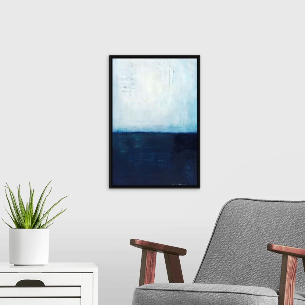 A modern room featuring Contemporary abstract painting using dark blue and light blue colors meeting almost in the middle...