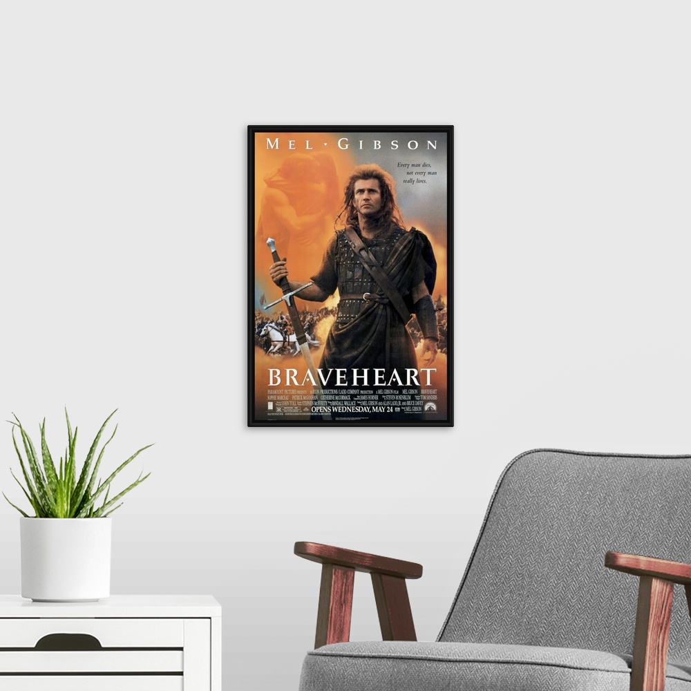 A modern room featuring Big, vertical movie advertisement on a wall hanging for Braveheart, Mel Gibson stands as a warrio...