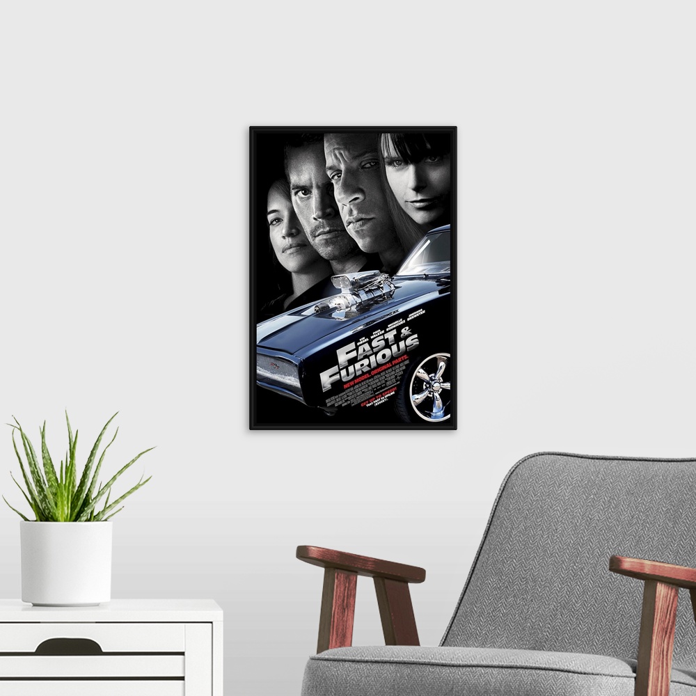 A modern room featuring Large, vertical movie advertisement for the Fast & Furious 4.  A muscle car in the foreground wit...