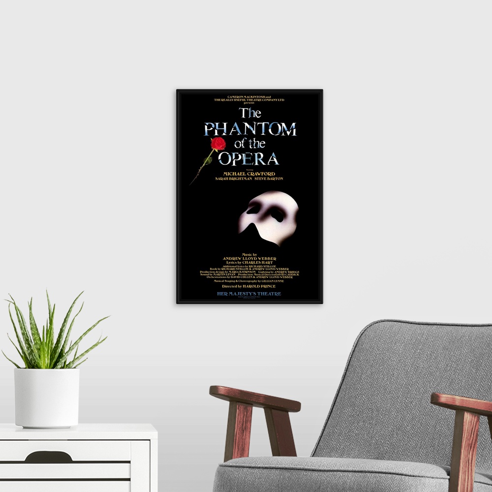 A modern room featuring Broadway poster for Andrew Lloyd Webber's play, The Phantom of the Opera, displaying the Phantom'...