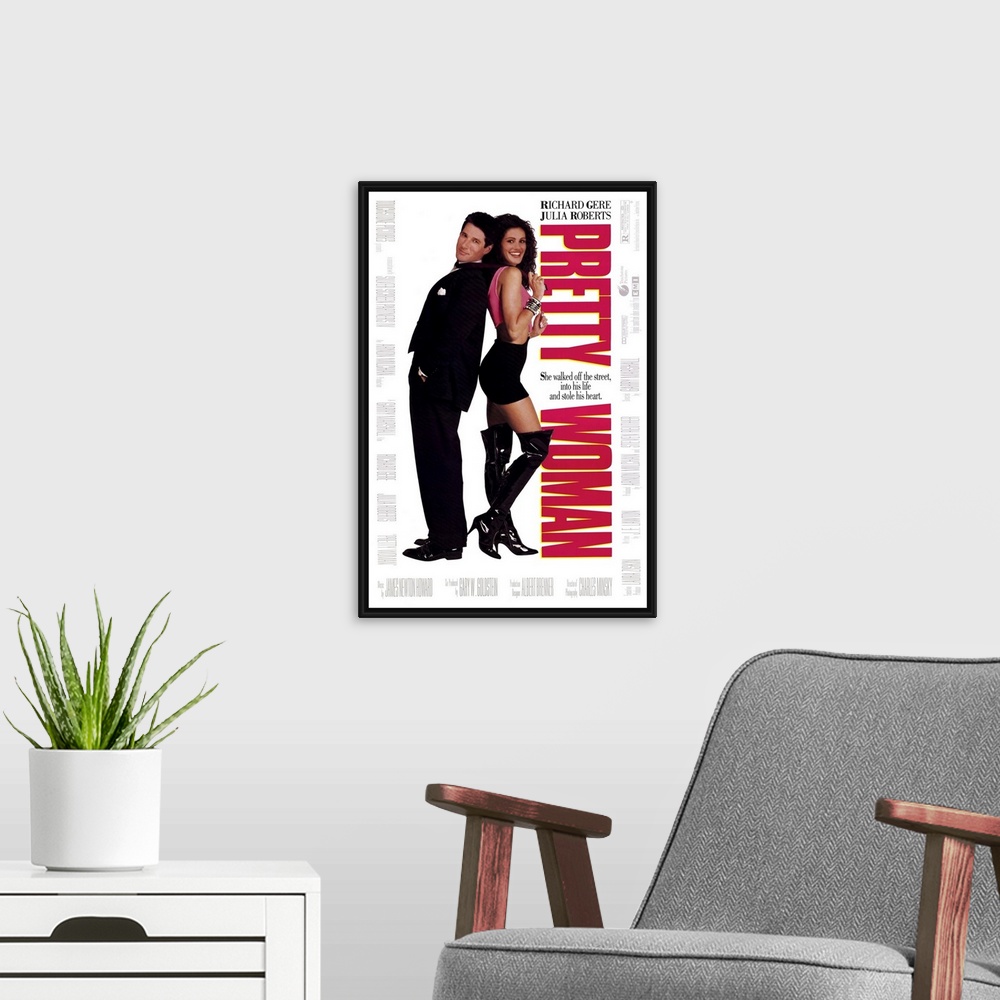 A modern room featuring Vertical, large movie advertisement for "Pretty Woman", with Julia Roberts and Richard Gere stand...
