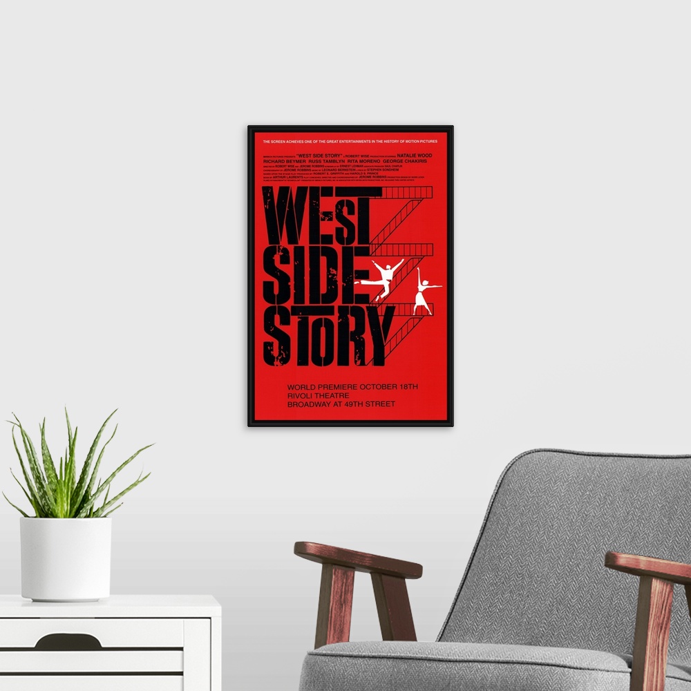A modern room featuring Broadway poster for the popular show "West Side Story". Flights of stairs go up the right side of...