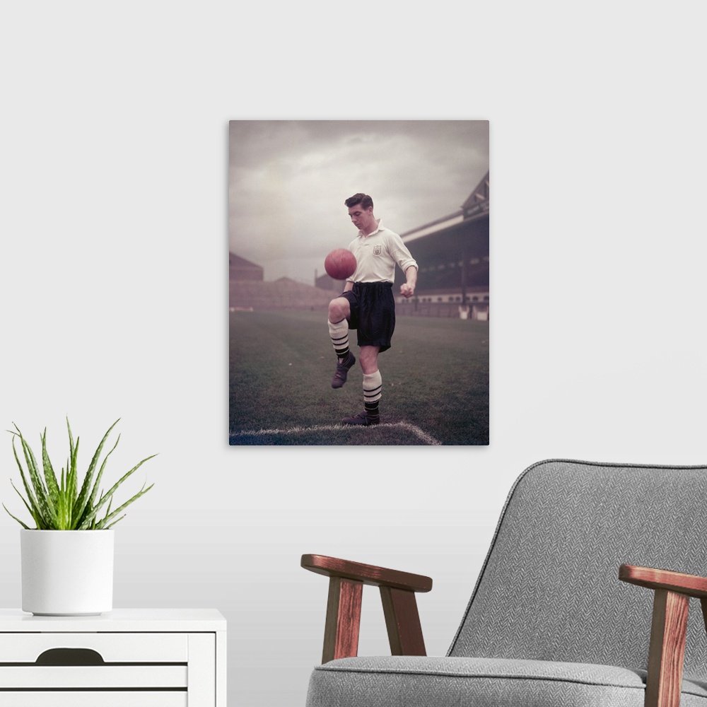 A modern room featuring England footballer and Fulham Football Club captain Johnny Haynes (1934 - 2005), circa 1955