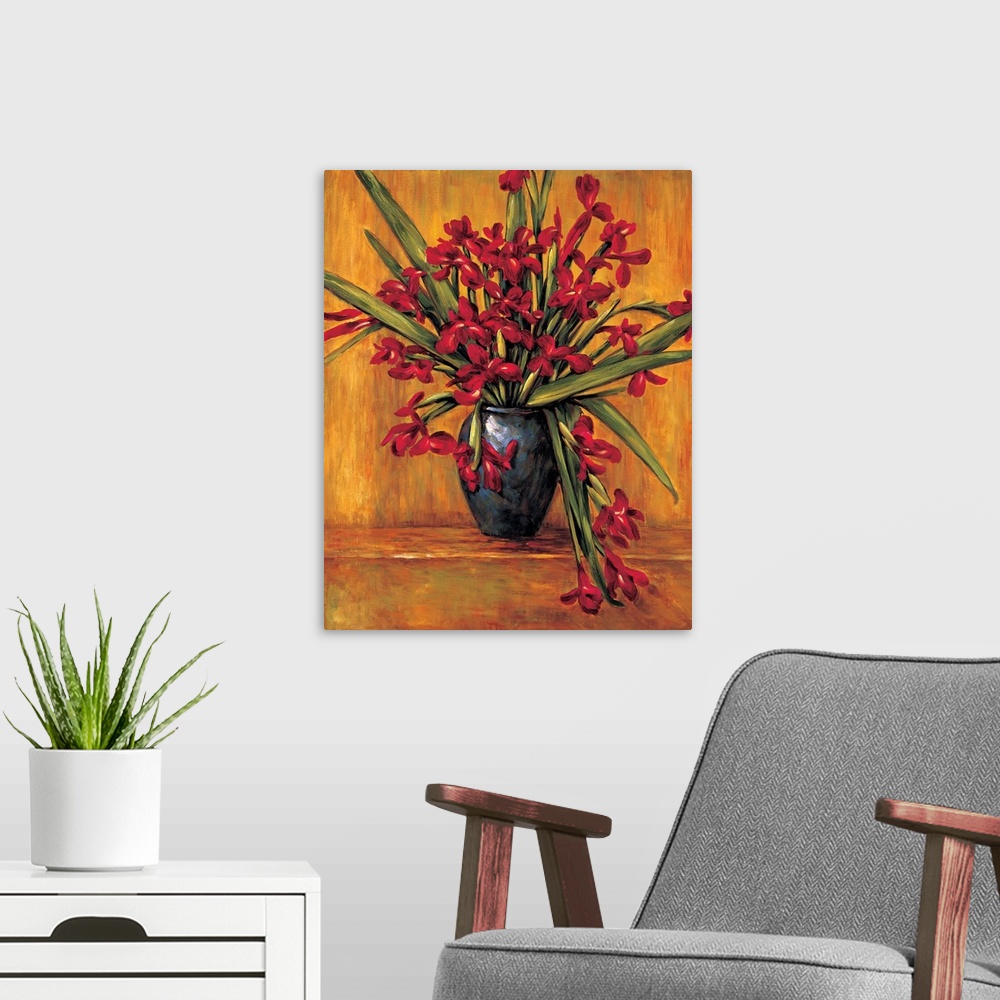 A modern room featuring Contemporary painting of red irises in a vase with an orange, red, and brown background.
