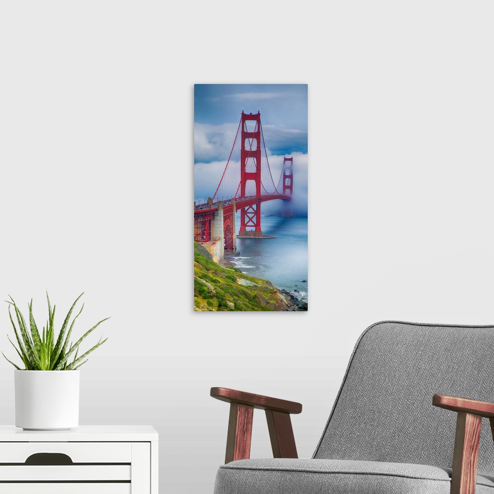 A modern room featuring Tall photograph of a green coast and the Golden Gate bridge with thick fog.