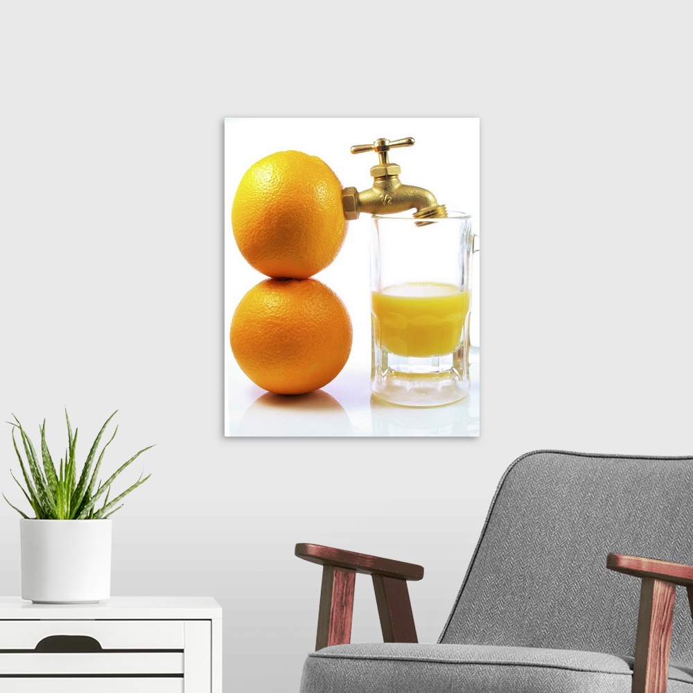 A modern room featuring Two oranges with spigot attached next to glass of orange juice on white background.