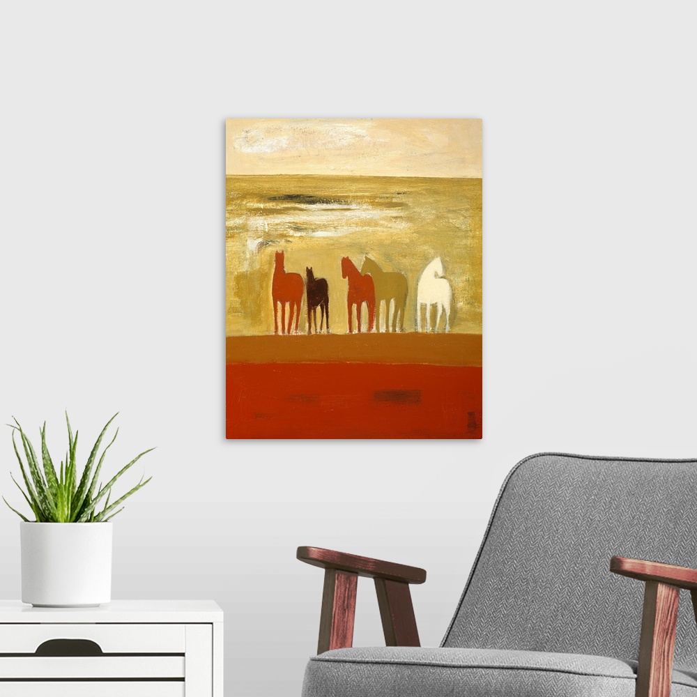 A modern room featuring Portrait painting on a large wall hanging of five silhouetted horses in various colors, standing ...