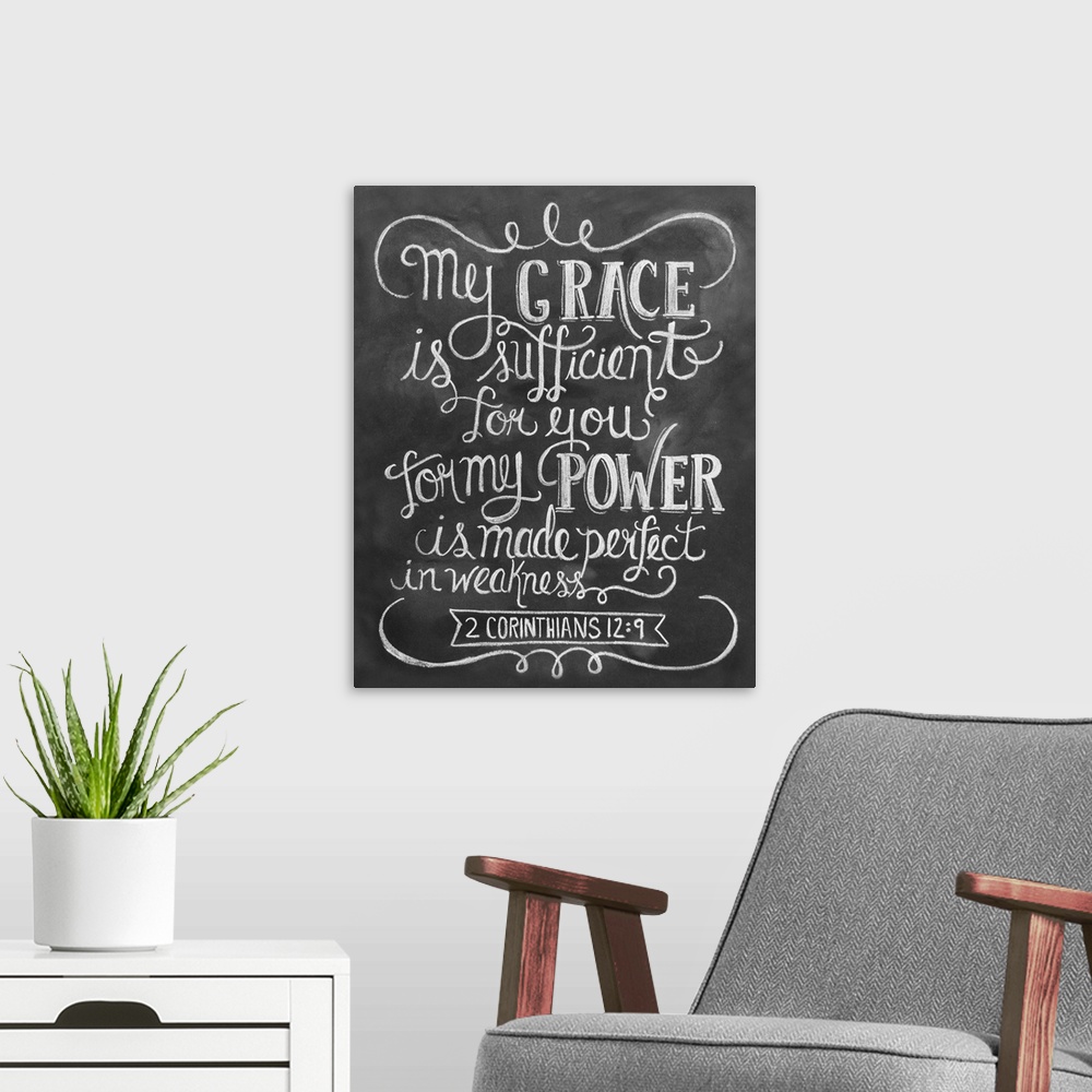 A modern room featuring The Bible passage 2 Corinthians 12:9 handwritten in white chalk on a black background.