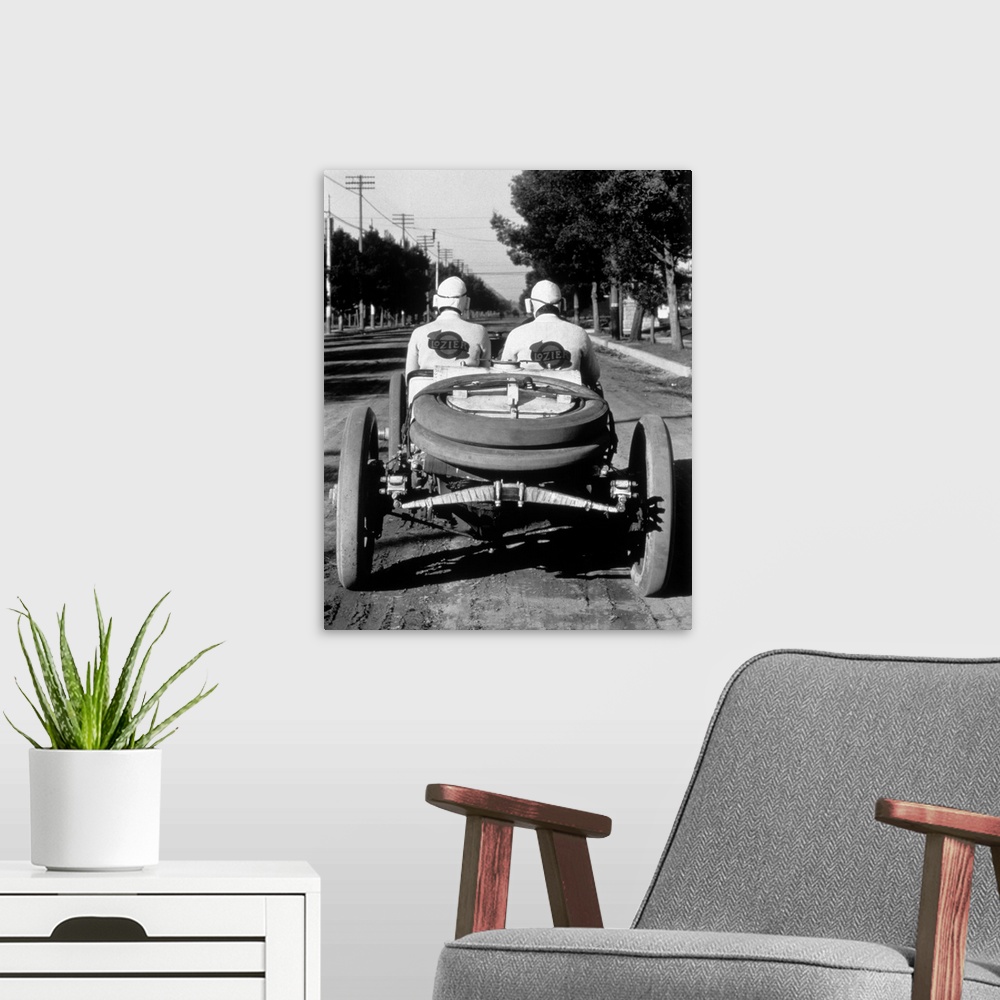 A modern room featuring 1900's 1910's Rear View Of Two Men Sitting In Antique Lozier Racing Road Rally Car.