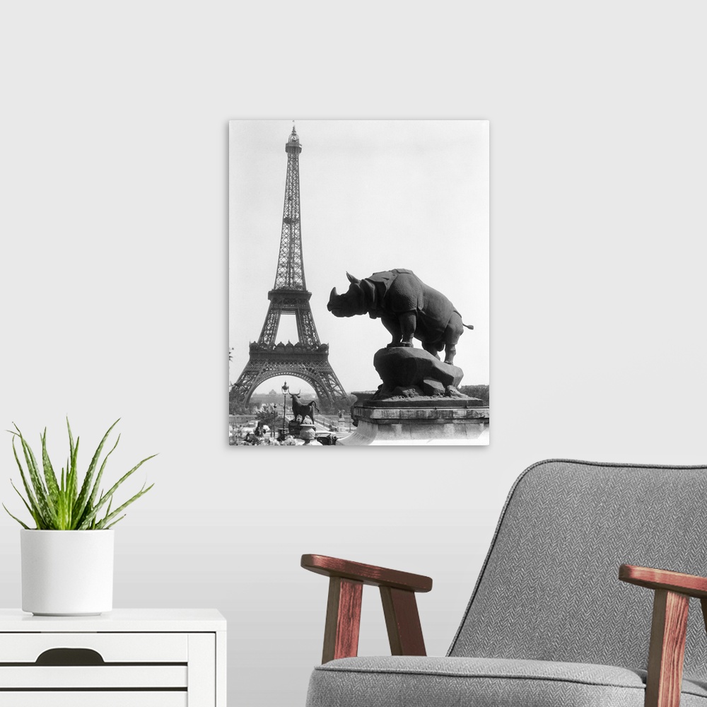 A modern room featuring 1920's Rhinoceros Statue In Foreground Eiffel Tower In Background Paris France.
