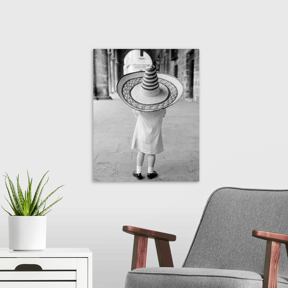 A modern room featuring 1950's 1960's Small Girl Tourist Seen From Behind Wearing Oversized Too Big Straw Hat.