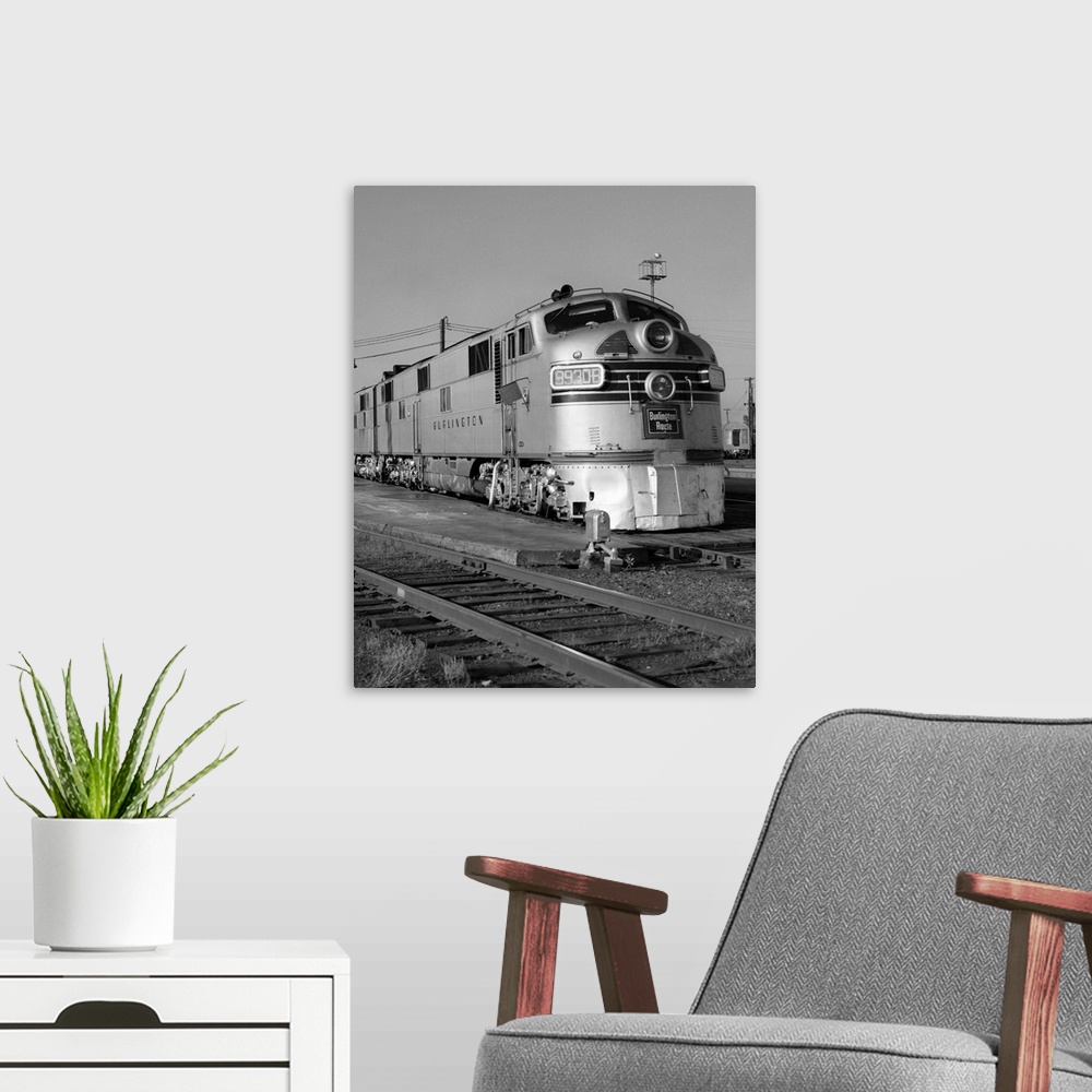 A modern room featuring 1950's 1960's Streamlined Burlington Route Railroad Train Diesel Locomotive Engine At Station.